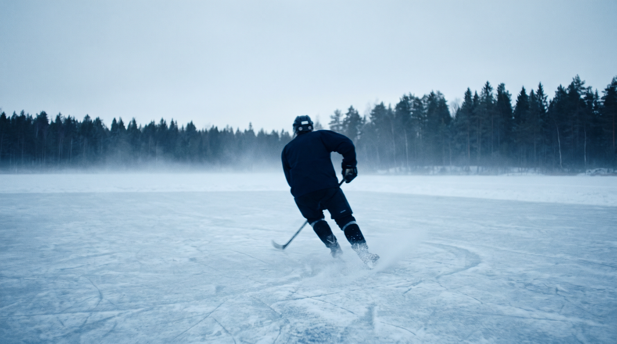 Eishockeyspieler auf gefrorener Eisfläche zur blauen Stunde – Rinkfolk Hero